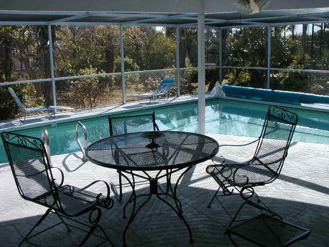 The pool area is has a screen enclosure and plenty of room for entertaining.