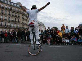 Bicyclist balances on front wheel.