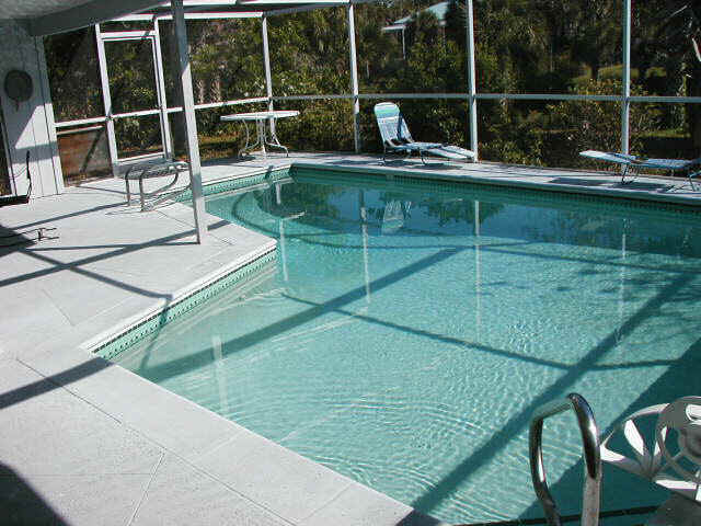 The pool area is has a screen enclosure and plenty of room for entertaining.